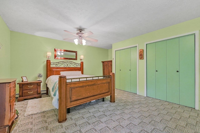 4301B W Sanborn Rd, Lake City, MI 49651 - bedroom with multiple closets, baseboard heating, a ceiling fan, a textured ceiling, and a baseboard radiator