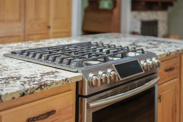4301B W Sanborn Rd, Lake City, MI 49651 - kitchen view of stainless steel range with gas cooktop and light stone countertops
