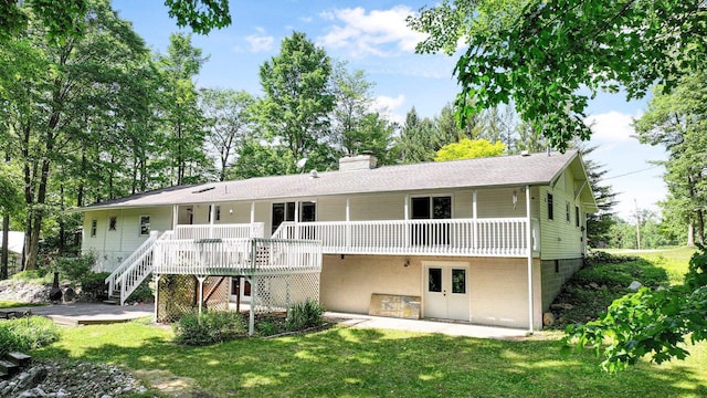 4301B W Sanborn Rd, Lake City, MI 49651 - rear view of property with a wooden deck, a patio area, a lawn, a chimney, and stairs