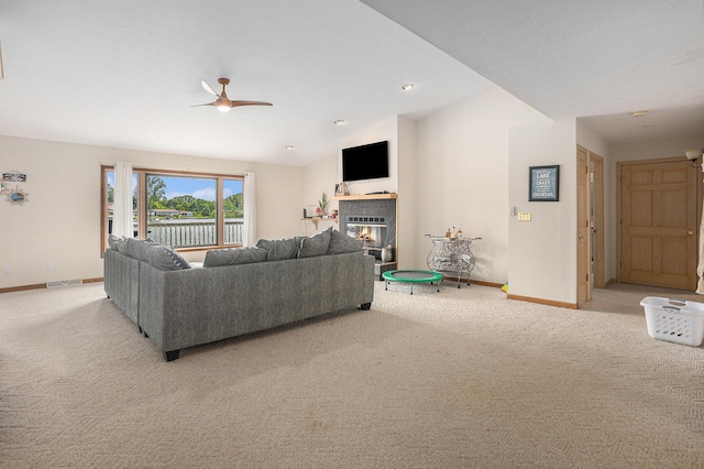 27418 Orchard Dr, Sturgis, MI 49091 - living area featuring light carpet, a tiled fireplace, lofted ceiling, and a ceiling fan