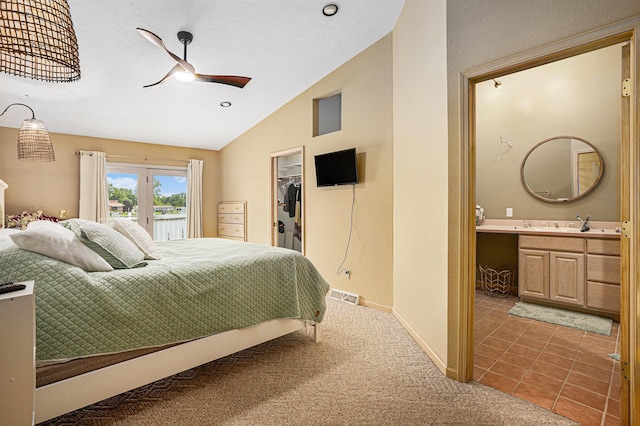 27418 Orchard Dr, Sturgis, MI 49091 - bedroom with vaulted ceiling, carpet, a spacious closet, connected bathroom, and a closet