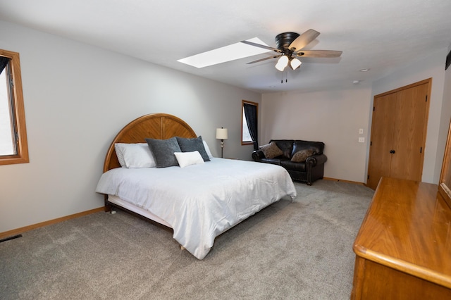 5825 Saddle Club Dr, Kalamazoo, MI 49009 - bedroom featuring a skylight, light carpet, and a ceiling fan