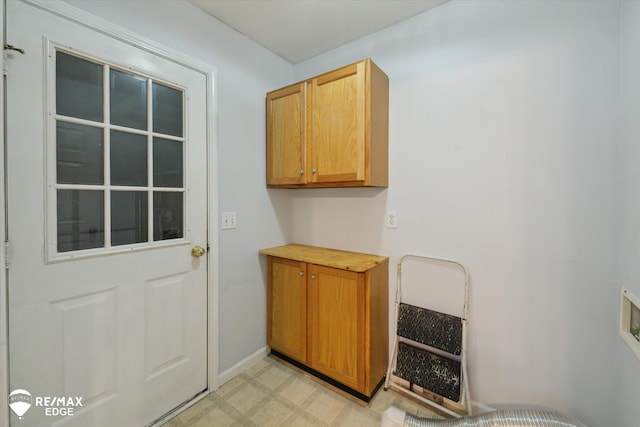 11419 Autumn Breeze Trl, Clio, MI 48420 - laundry room featuring cabinet space and light flooring