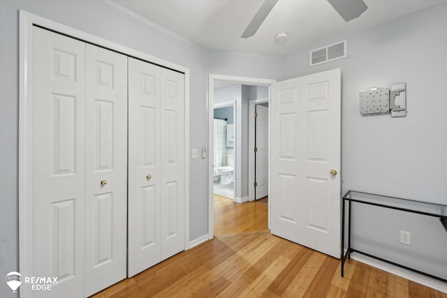 11419 Autumn Breeze Trl, Clio, MI 48420 - unfurnished bedroom featuring light wood-type flooring, a closet, and a ceiling fan
