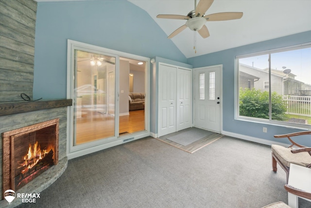 11419 Autumn Breeze Trl, Clio, MI 48420 - unfurnished room with a ceiling fan, vaulted ceiling, carpet flooring, and a fireplace