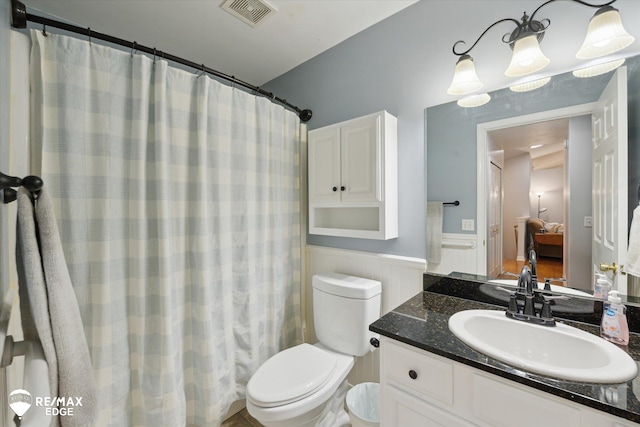 11419 Autumn Breeze Trl, Clio, MI 48420 - ensuite bathroom with wainscoting, vanity, and a shower with shower curtain