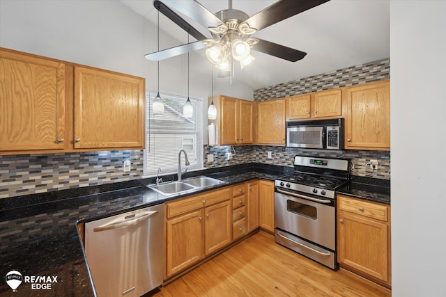 11419 Autumn Breeze Trl, Clio, MI 48420 - kitchen featuring appliances with stainless steel finishes, vaulted ceiling, a ceiling fan, light wood-style floors, and tasteful backsplash