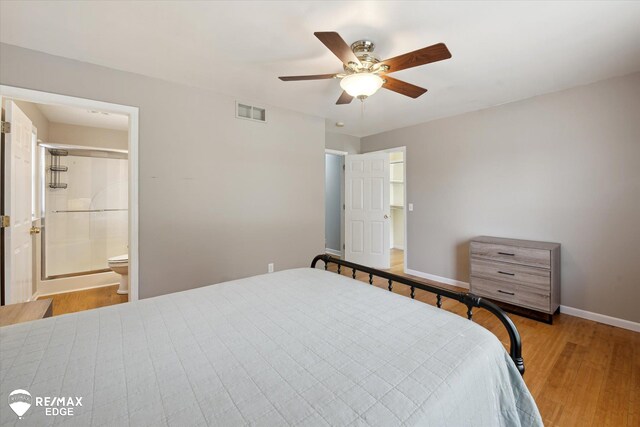 11419 Autumn Breeze Trl, Clio, MI 48420 - bedroom with wood finished floors, ensuite bath, and a ceiling fan
