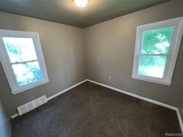 182 Crystal Lake Dr, Pontiac, MI 48341 - spare room featuring healthy amount of natural light and dark colored carpet