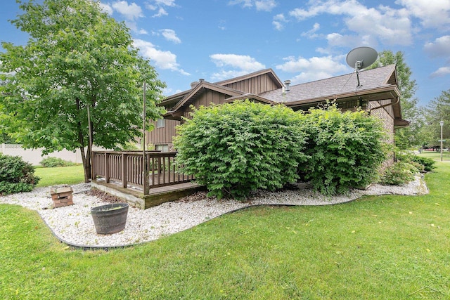 4918 Frontier Ln, Saginaw, MI 48603 - view of grassy yard with a wooden deck