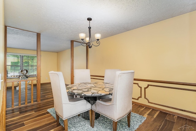 4918 Frontier Ln, Saginaw, MI 48603 - dining room with wood finished floors, a textured ceiling, and a chandelier