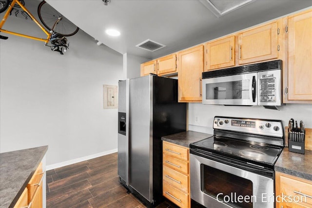600 Monroe Ave NW Unit 409, Grand Rapids, MI 49503 - kitchen with stainless steel appliances, light brown cabinetry, dark countertops, and dark wood-style floors