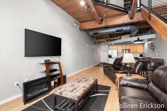 600 Monroe Ave NW Unit 409, Grand Rapids, MI 49503 - living area with light wood finished floors, a high ceiling, and beamed ceiling