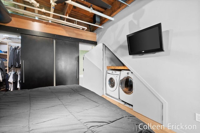 600 Monroe Ave NW Unit 409, Grand Rapids, MI 49503 - washroom featuring washing machine and clothes dryer and wood finished floors