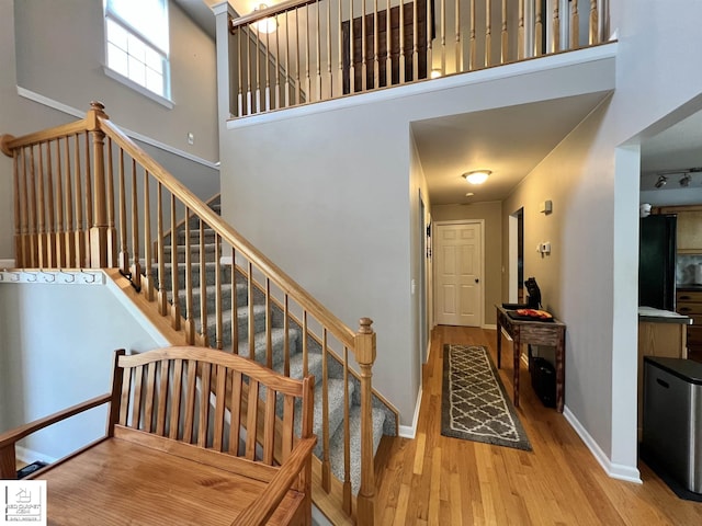 1306 Rosalie Dr, Fenton, MI 48430 - staircase with wood finished floors and a high ceiling