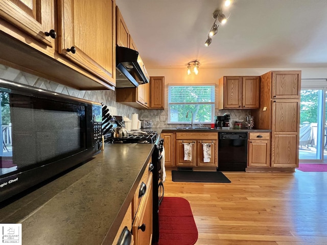 1306 Rosalie Dr, Fenton, MI 48430 - kitchen with black appliances, exhaust hood, dark countertops, and healthy amount of natural light
