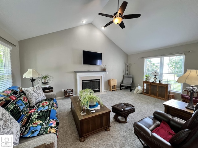 1306 Rosalie Dr, Fenton, MI 48430 - living area featuring lofted ceiling, a ceiling fan, carpet, and a fireplace with flush hearth