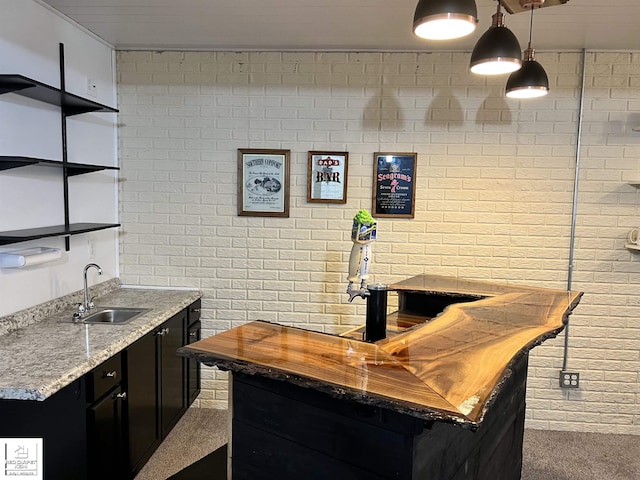 1306 Rosalie Dr, Fenton, MI 48430 - indoor wet bar featuring brick wall, carpet floors, and pendant lighting