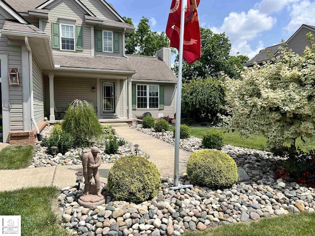 1306 Rosalie Dr, Fenton, MI 48430 - view of front of house featuring a chimney and a shingled roof