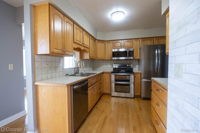 1660 River Rd Unit 7, Marysville, MI 48040 - kitchen with appliances with stainless steel finishes, light wood-style floors, light countertops, decorative backsplash, and brown cabinets