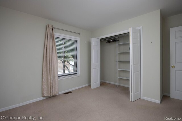 1660 River Rd Unit 7, Marysville, MI 48040 - unfurnished bedroom featuring carpet floors and a closet