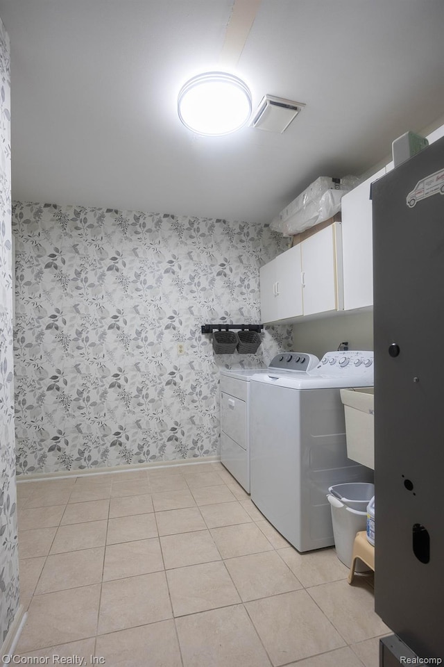 1660 River Rd Unit 7, Marysville, MI 48040 - laundry room featuring cabinet space, washing machine and dryer, light tile patterned floors, and wallpapered walls