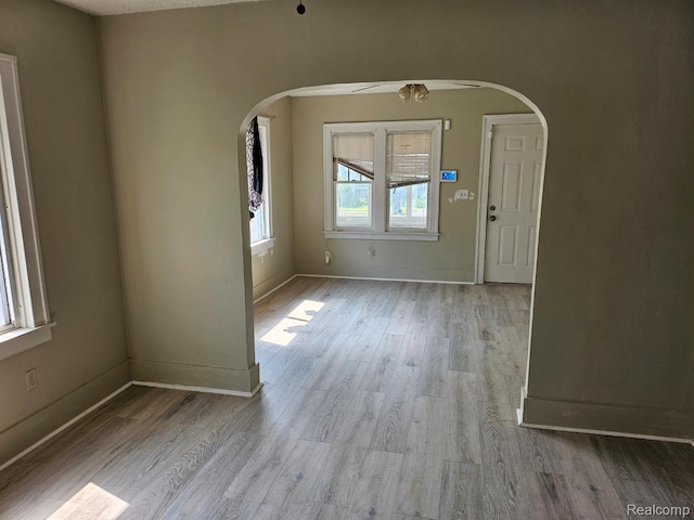 1102 W Atherton Rd W, Flint, MI 48507 - foyer entrance with arched walkways, wood finished floors, and a ceiling fan
