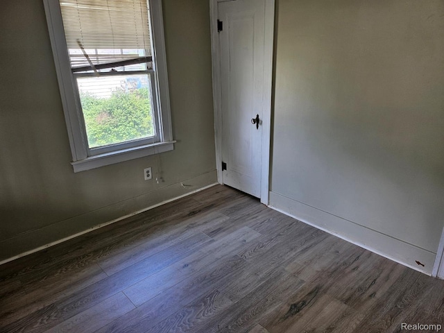 1102 W Atherton Rd W, Flint, MI 48507 - spare room featuring dark wood finished floors and baseboards