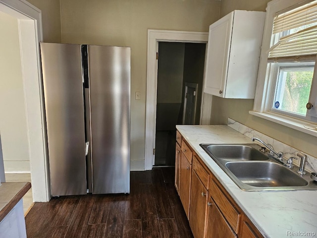 1102 W Atherton Rd W, Flint, MI 48507 - kitchen featuring freestanding refrigerator, dark wood finished floors, brown cabinetry, and white cabinets