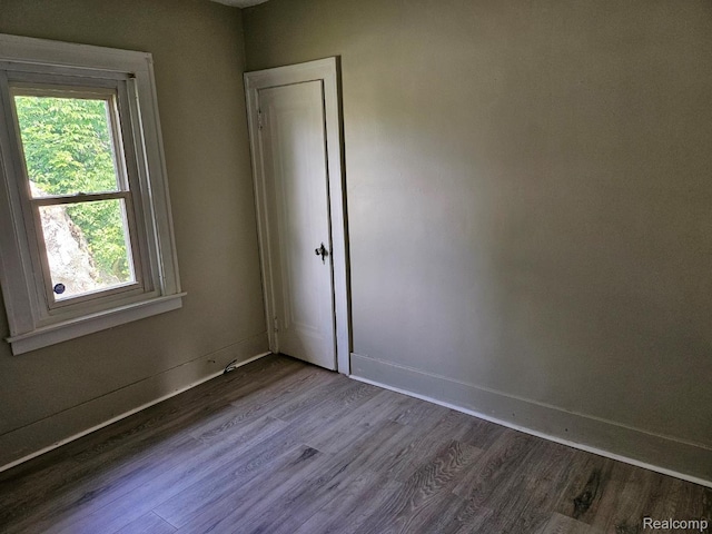 1102 W Atherton Rd W, Flint, MI 48507 - empty room with dark wood-type flooring and baseboards