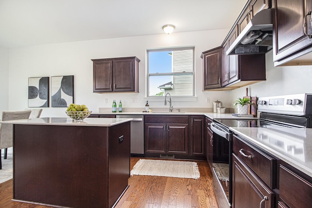 6378 N Trailwoods Dr, Ann Arbor, MI 48103 - kitchen with appliances with stainless steel finishes, under cabinet range hood, dark wood-type flooring, and light countertops
