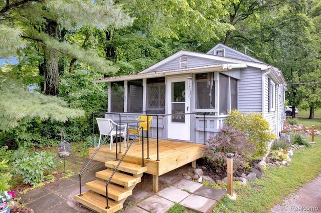 4155 Mill Lake Rd, Lake Orion, MI 48360 - view of front of house featuring a sunroom, a deck, and view of scattered trees