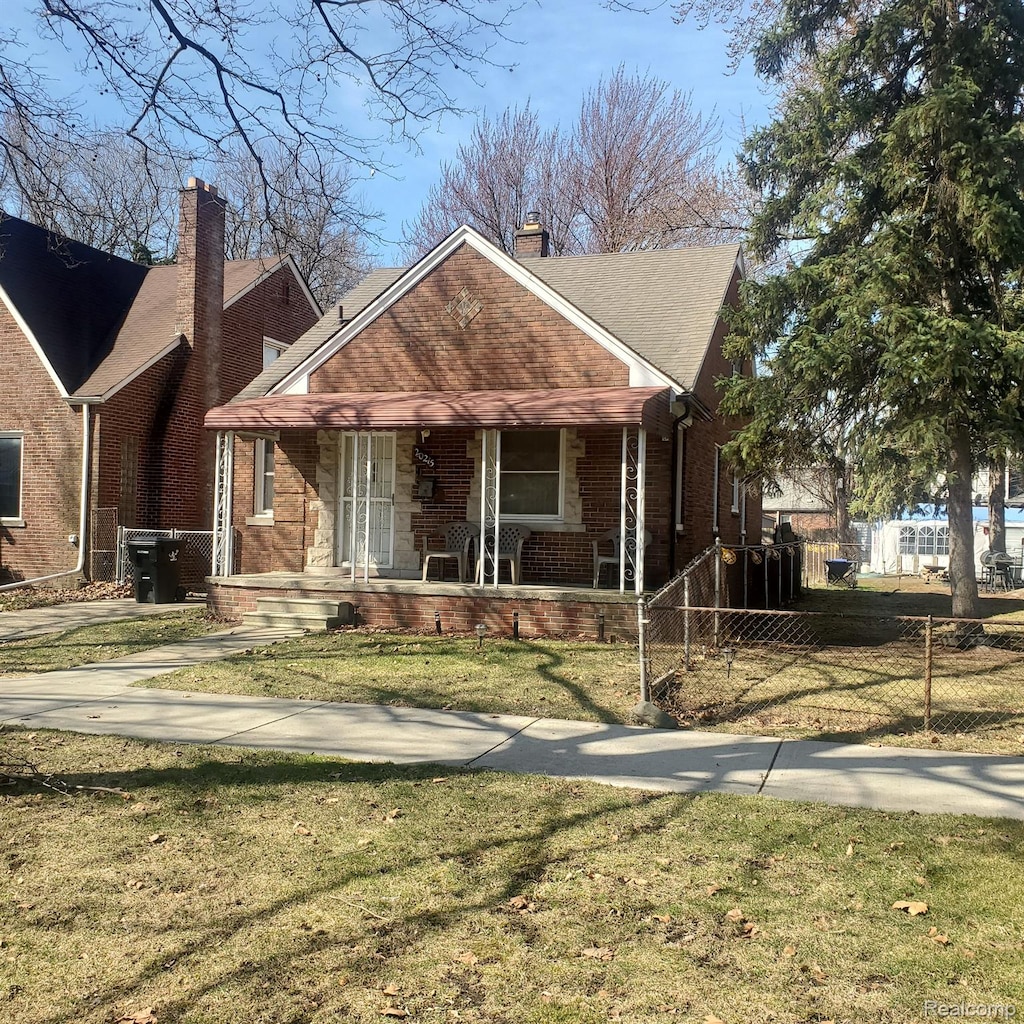 20215 Stotter St, Detroit, MI 48234 - view of front facade featuring brick siding, a chimney, and a porch