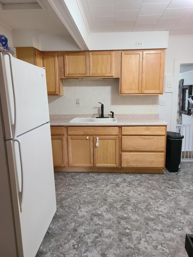 901 Helena Ave, Jackson, MI 49203 - kitchen with freestanding refrigerator, decorative backsplash, and light countertops