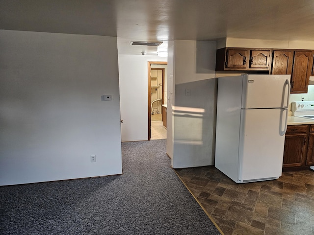 8867 W Garfield Rd, Shelby, MI 49455 - kitchen featuring freestanding refrigerator, stove, light countertops, and dark brown cabinets