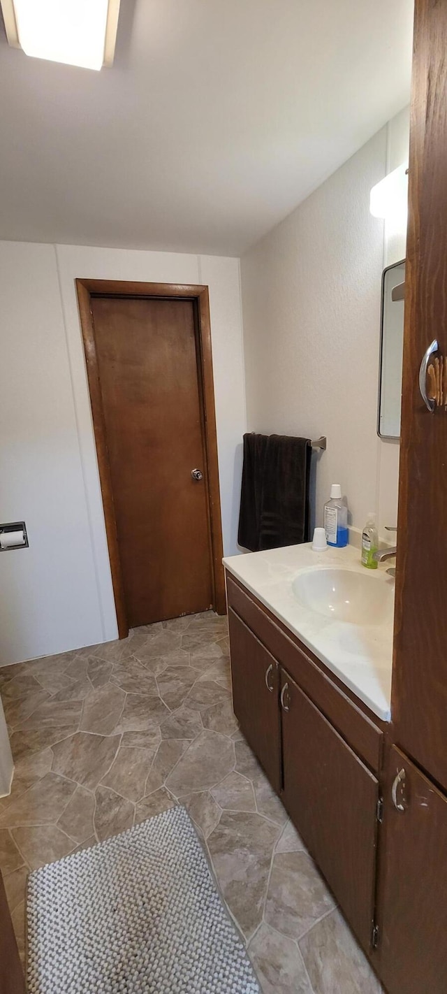 8867 W Garfield Rd, Shelby, MI 49455 - bathroom with vanity and stone finish floors