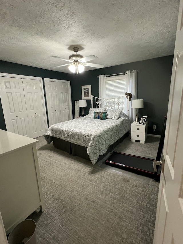 5437 Grand River Dr NE, Grand Rapids, MI 49525 - carpeted bedroom featuring two closets, a ceiling fan, and a textured ceiling