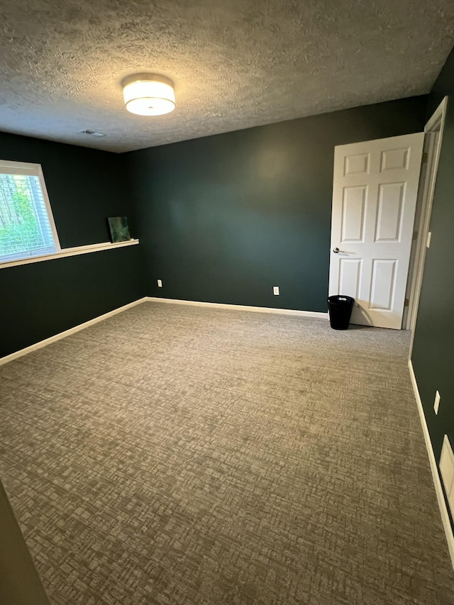 5437 Grand River Dr NE, Grand Rapids, MI 49525 - empty room featuring carpet flooring and a textured ceiling