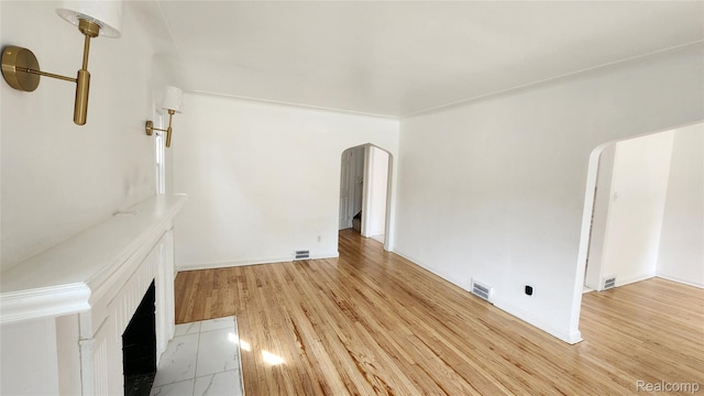 10947 Roxbury St, Detroit, MI 48224 - unfurnished living room featuring arched walkways and wood finished floors