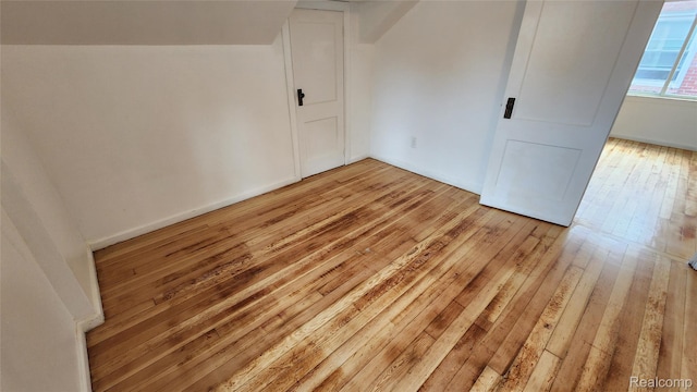 10947 Roxbury St, Detroit, MI 48224 - unfurnished bedroom featuring light wood-style flooring and lofted ceiling