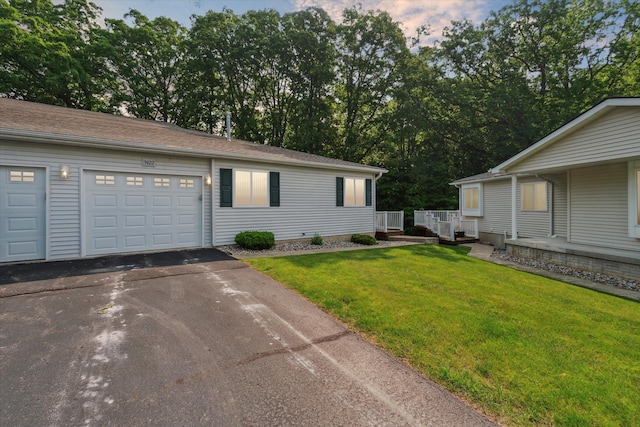 9422 Timber Ridge Dr, Grand Blanc, MI 48439 - view of front of property featuring asphalt driveway, a front lawn, and view of wooded area