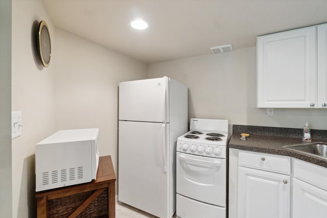 9422 Timber Ridge Dr, Grand Blanc, MI 48439 - kitchen featuring white appliances, dark countertops, white cabinetry, and recessed lighting