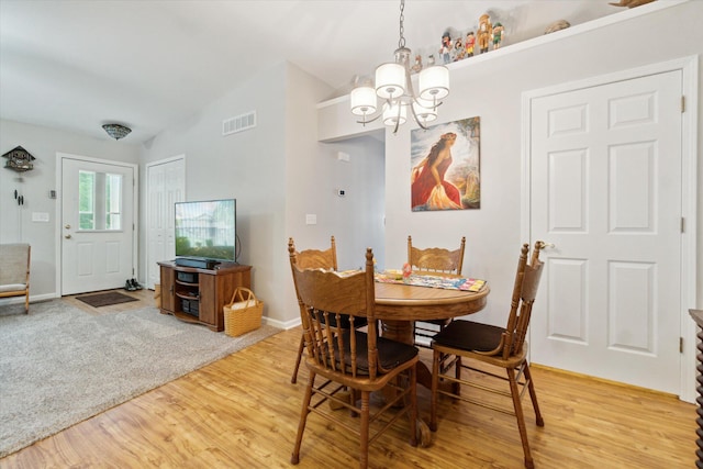 9422 Timber Ridge Dr, Grand Blanc, MI 48439 - dining space with a chandelier, vaulted ceiling, and light wood-style flooring