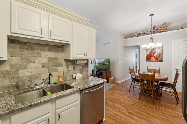 9422 Timber Ridge Dr, Grand Blanc, MI 48439 - kitchen featuring stainless steel dishwasher, a chandelier, decorative backsplash, pendant lighting, and light wood-style flooring