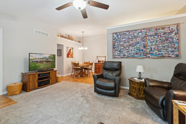 9422 Timber Ridge Dr, Grand Blanc, MI 48439 - carpeted living room with a chandelier, ceiling fan, and wood finished floors