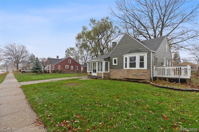 20628 Alger St, Saint Clair Shores, MI 48080 - view of side of home with stone siding, a deck, and roof with shingles