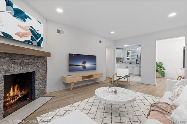 20628 Alger St, Saint Clair Shores, MI 48080 - living room featuring a fireplace, light wood-type flooring, and recessed lighting