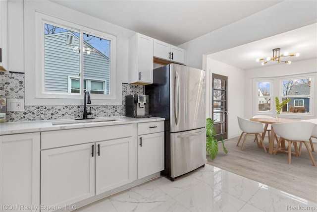 20628 Alger St, Saint Clair Shores, MI 48080 - kitchen with freestanding refrigerator, decorative backsplash, a chandelier, white cabinets, and light countertops