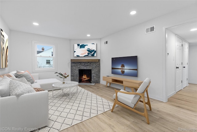 20628 Alger St, Saint Clair Shores, MI 48080 - living area with wood finished floors, recessed lighting, and a stone fireplace
