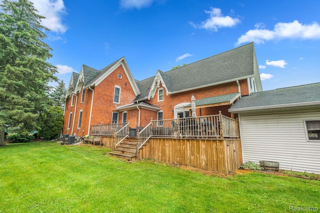 1666 Capac Rd, Berlin, MI 48002 - rear view of property with brick siding, a deck, and a lawn